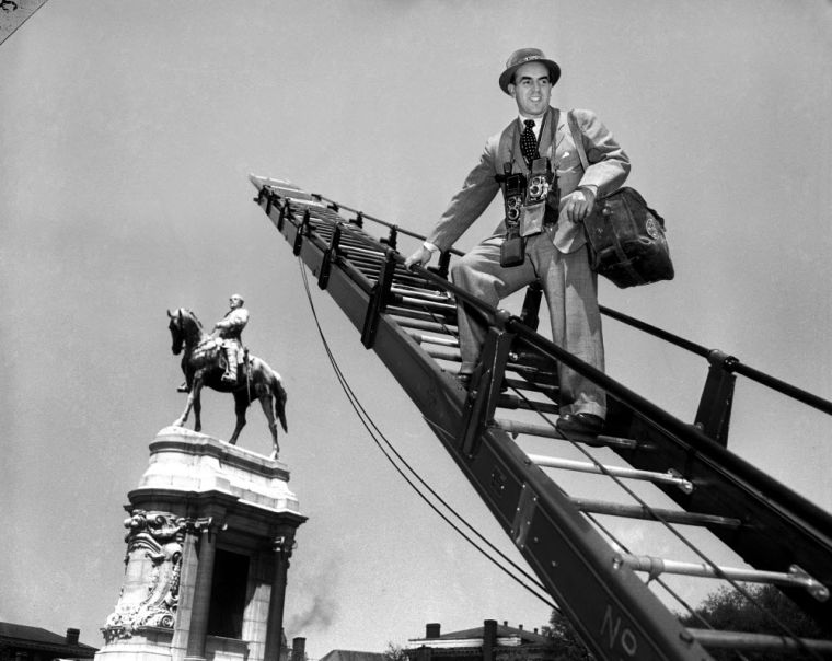 HIGHER THAN LEE?--Ewing Krainin is the only person in Richmond to look down on General Lee...and he's only doing it for business reasons. Here to do a series of pictures on Richmond for a national magazine, Krainin has had to enlist the aid of the Fire D